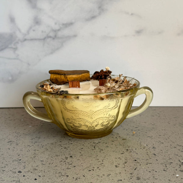 Decorative glass bowl with small items on a marble surface