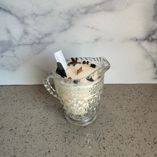 Glass container with a white substance on a marble and concrete surface