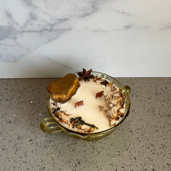 vintage candle with natural elements on a marble and concrete surface