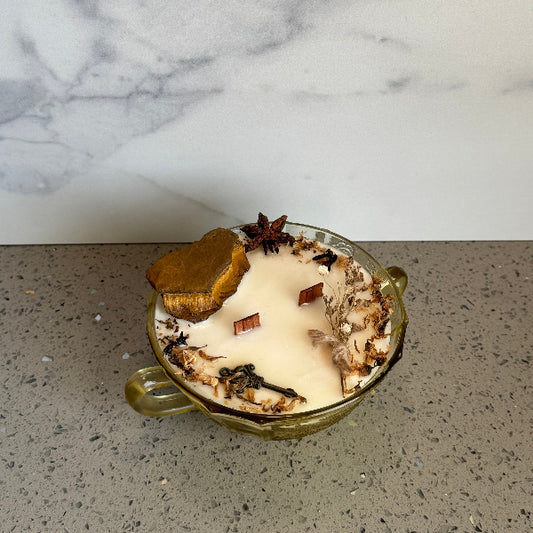 vintage candle with natural elements on a marble and concrete surface