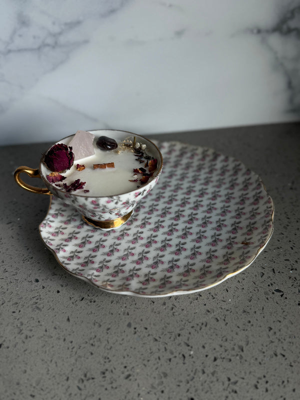 Vintage teacup and saucer with floral pattern on a marble surface