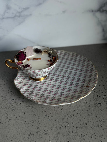 Vintage teacup and saucer with floral pattern on a marble surface