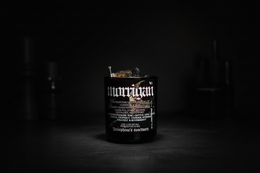 Hand-poured Morrígan ritual candle for protection, shadow work, and sovereignty. Dark, resinous scent with crystals and sacred botanicals.
