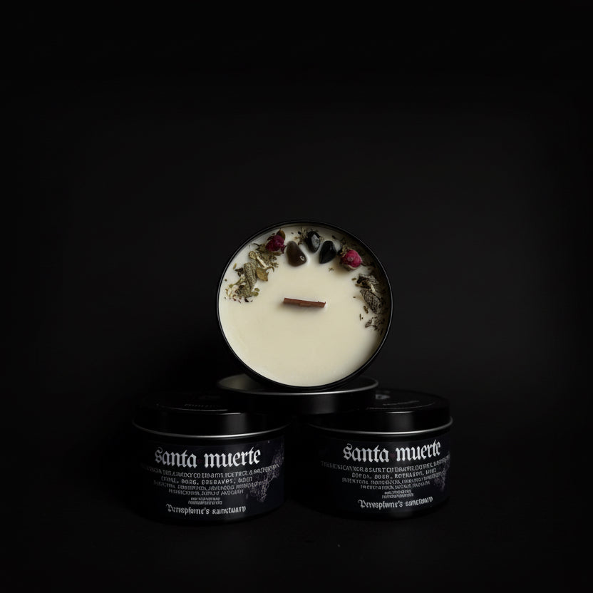 Candle with decorative elements in a black container labeled 'Santa Muerte' on a dark background